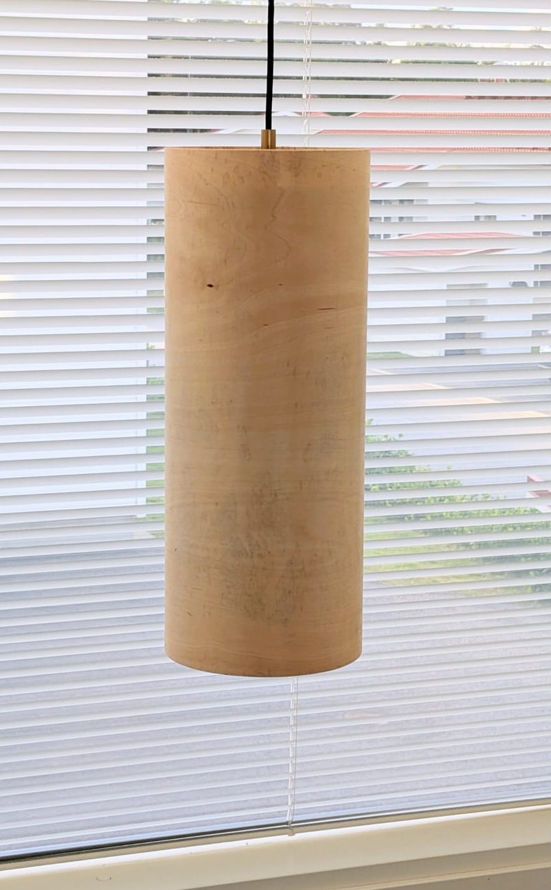 The lamp switched off: a pale birch cylinder
