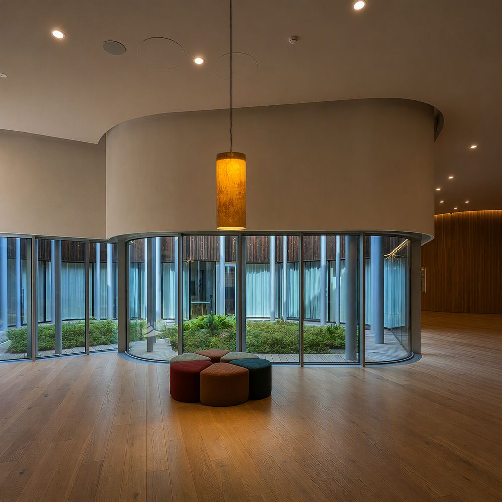 A pendant in a calm lobby with oak floors